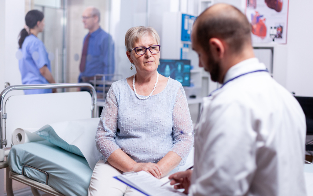 senior-woman-answering-doctor-questions-examination-hospital-room (1) (1).jpg