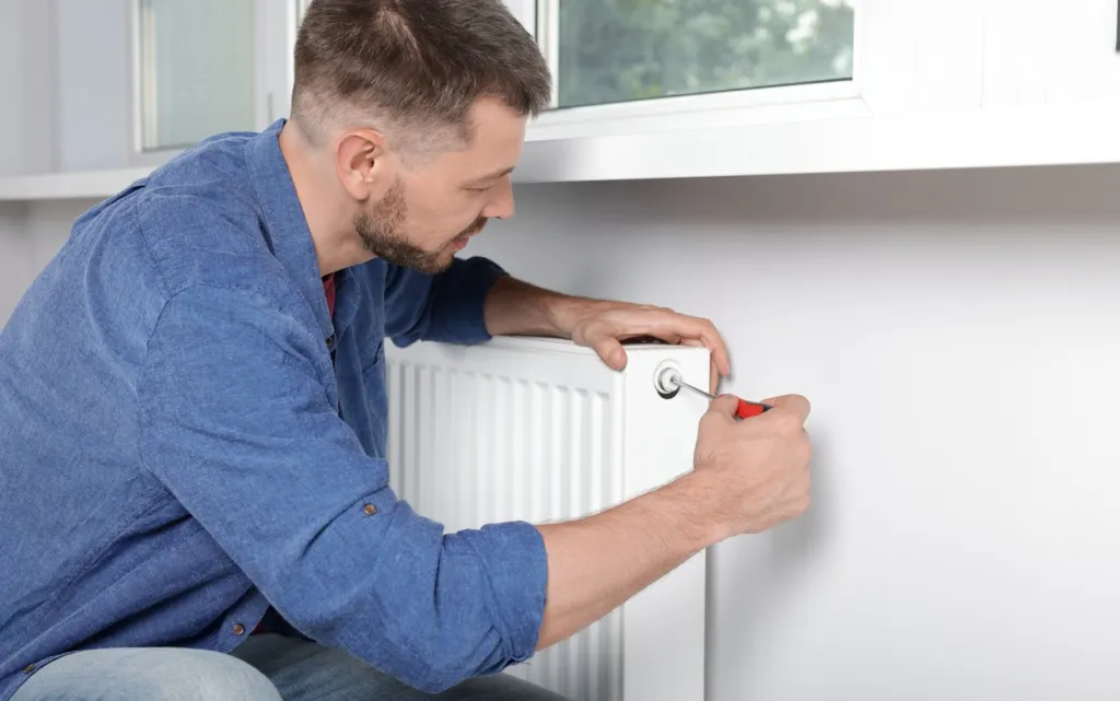 man-repairing-radiator-with-screwdriver-in-home-2026-09-25-01-31-09-utc (1).jpg