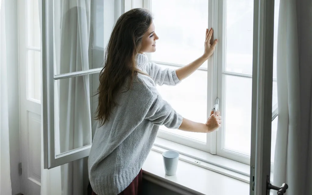 woman-opening-window-in-cozy-home-setting-2026-09-22-15-44-32-utc (1).jpg