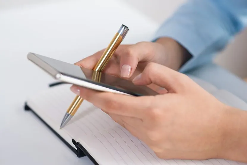 closeup-person-texting-smartphone-working-desk.jpg