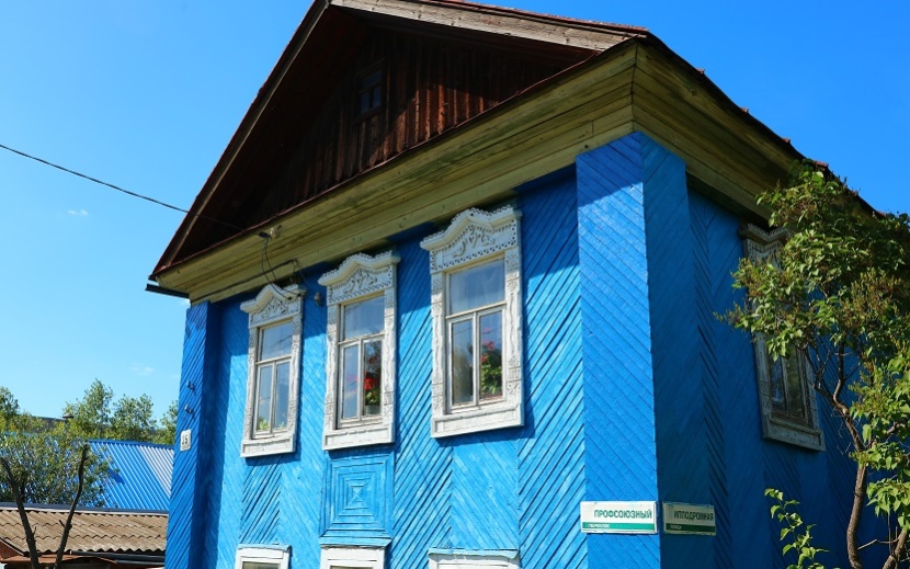 Красивый синий домик с белыми наличниками