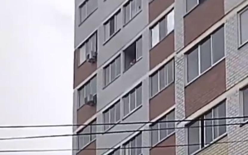 Мужчина сбрасывает окно из дома на ул. Ленина в Ижевске. Видео: vk.com/zlou18