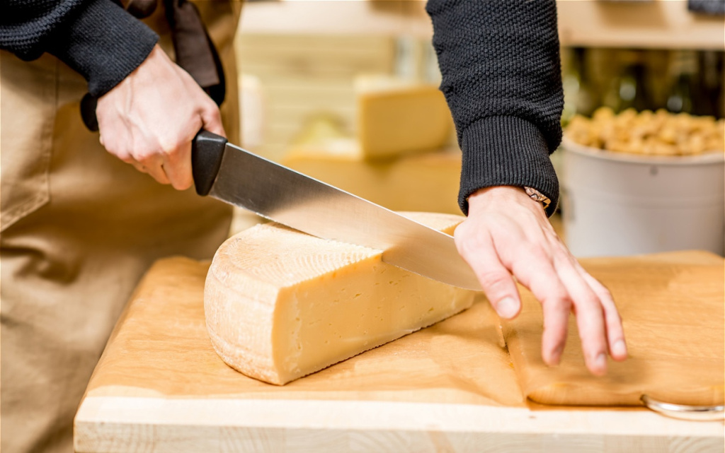 cutting-round-of-cheese-on-cutting-board-2026-03-20-04-33-47-utc (1).jpg