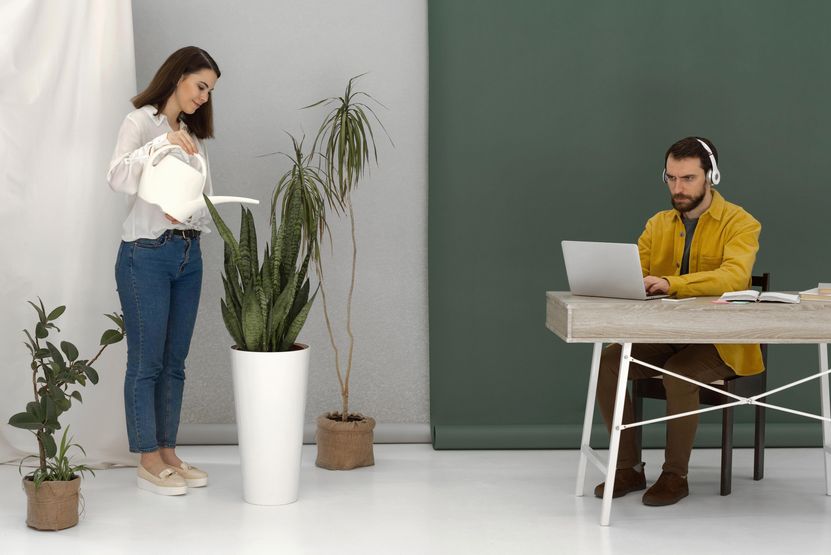 woman-watering-plant-man-using-laptop.jpg