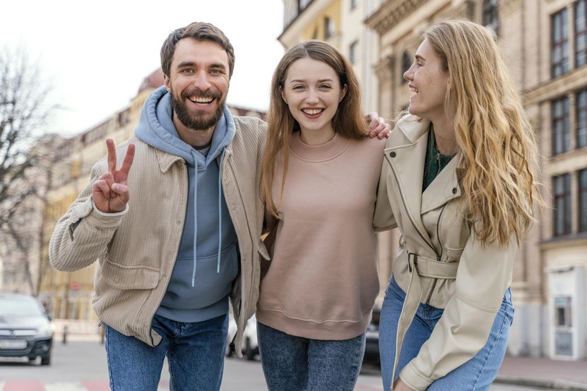 group-smiley-friends-outdoors-city-posing.jpg