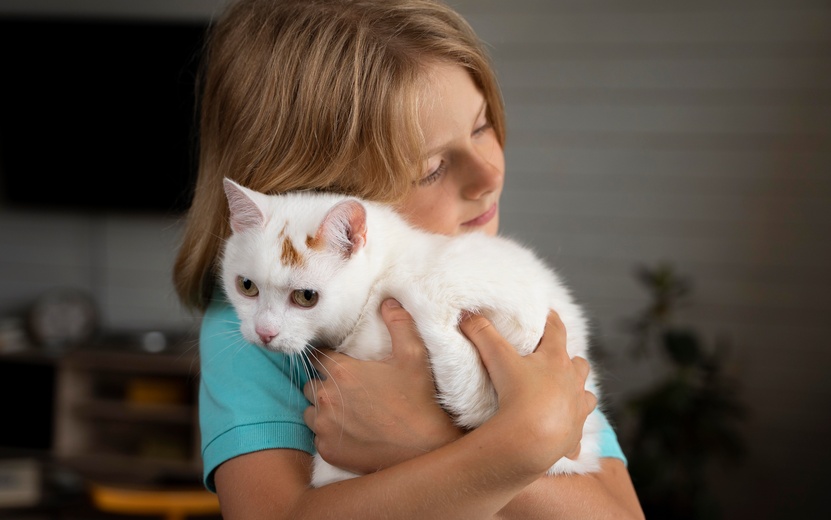 medium-shot-kid-hugging-cat (1).jpg