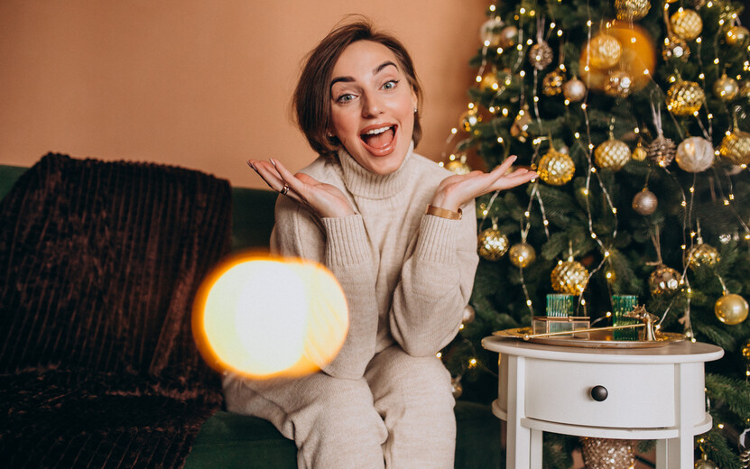 result_happy-woman-sitting-sofa-by-christmas-tree.jpg