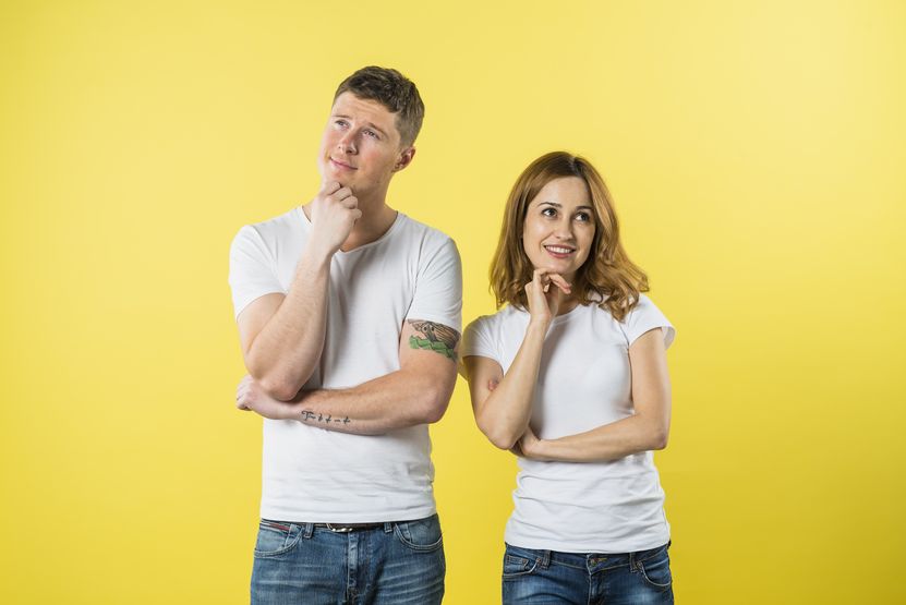 portrait-young-couple-daydreaming-against-yellow-background.jpg