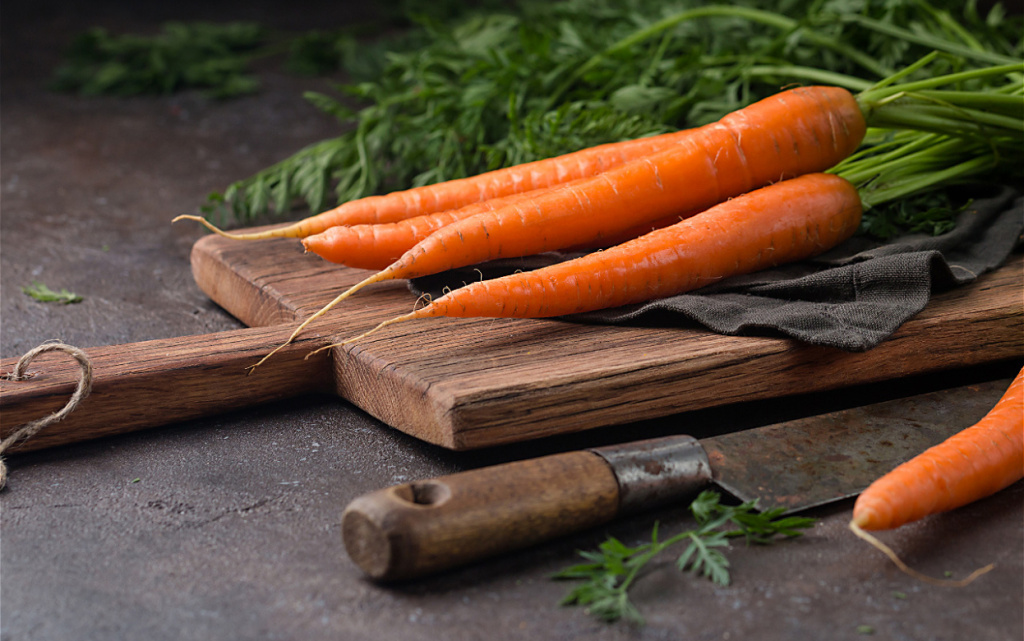 fresh-carrots-on-wooden-board-with-rustic-knife-2026-03-16-22-56-34-utc (1).jpg