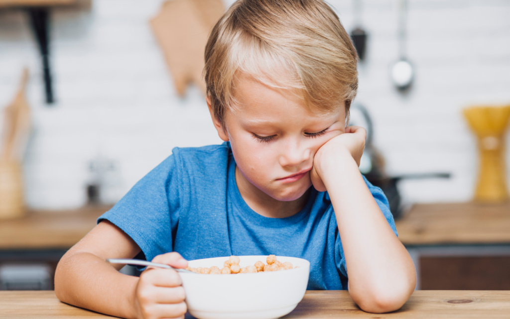 tired-boy-trying-eat-his-cereals (1).jpg