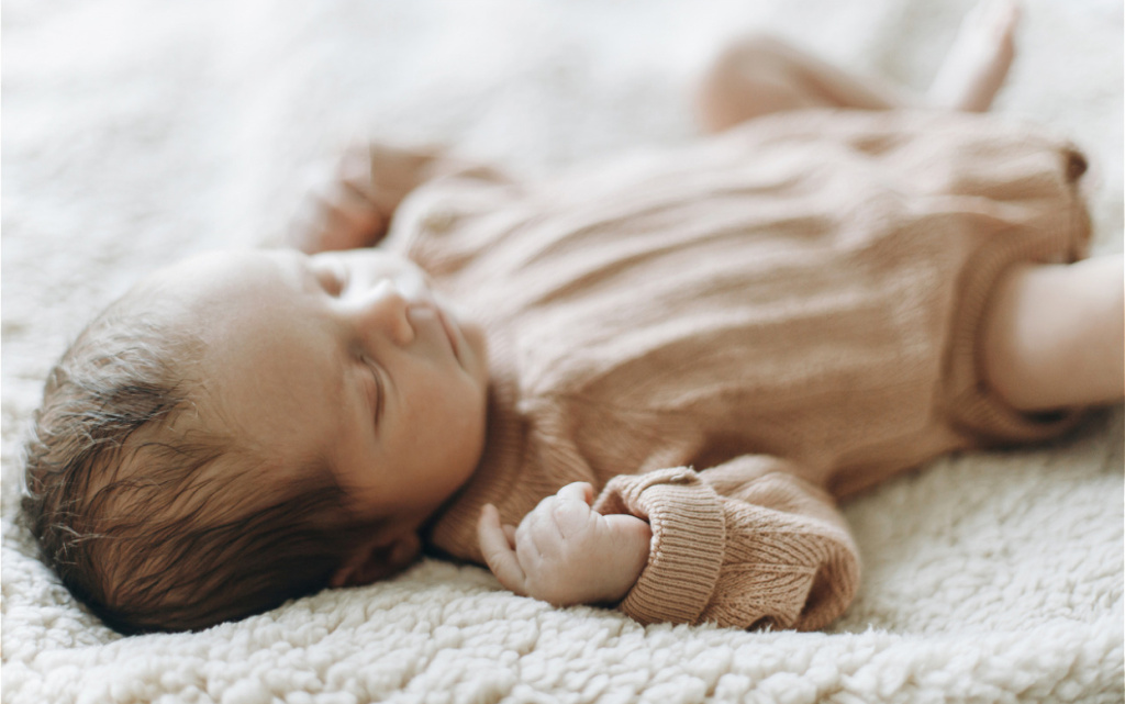 sleeping-infant-in-a-beige-outfit-on-blanket-2026-09-24-13-11-59-utc (1).jpg