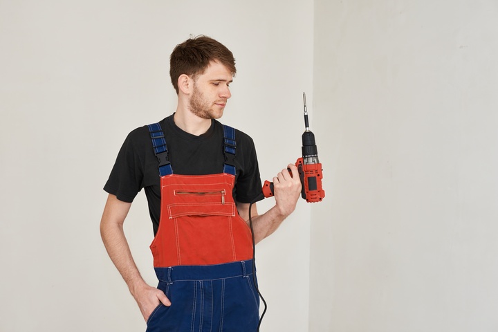 man-holding-power-drill-indoors-wearing-overalls-2026-01-07-02-19-47-utc (1).jpg