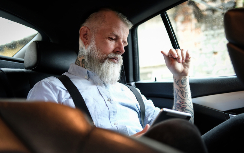 old-man-businessman-with-tablet-inside-car-in-dayt-2023-11-27-05-26-57-utc.jpg