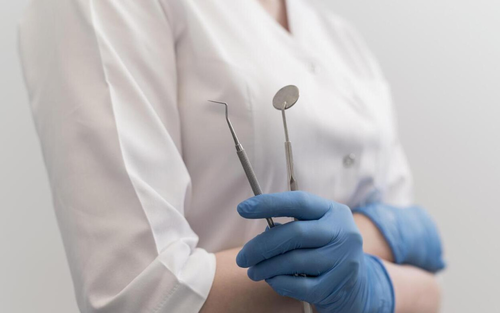 female-orthodontist-with-latex-gloves-handling-dental-equipment (1) (1).jpg