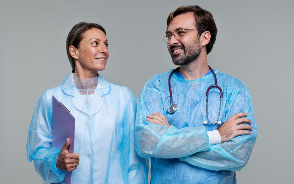 portrait-man-woman-wearing-medical-gowns-holding-clipboard (1).jpg