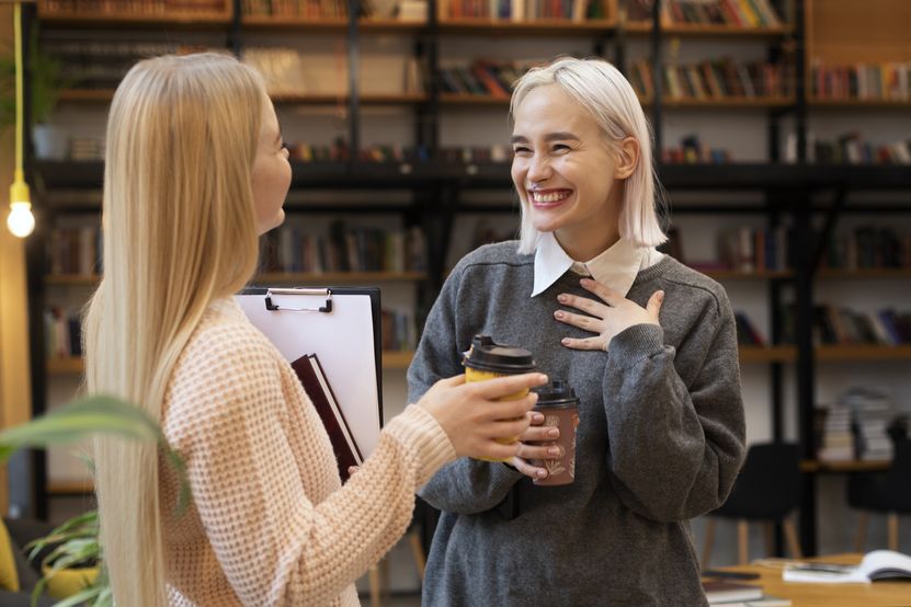 female-friends-taking-books-from-library-drinking-coffee.jpg