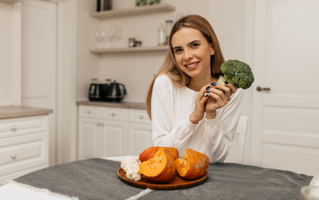 spectacular-smiling-lady-sitting-kitchen-with-broccoli-pumpkin-preparing-cooking (1).jpg