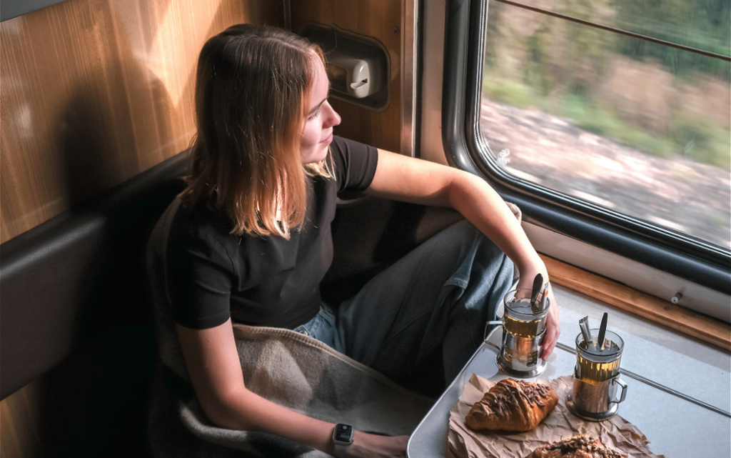 woman-enjoying-train-ride-with-pastries-and-tea-2026-01-08-07-51-24-utc (1).jpg