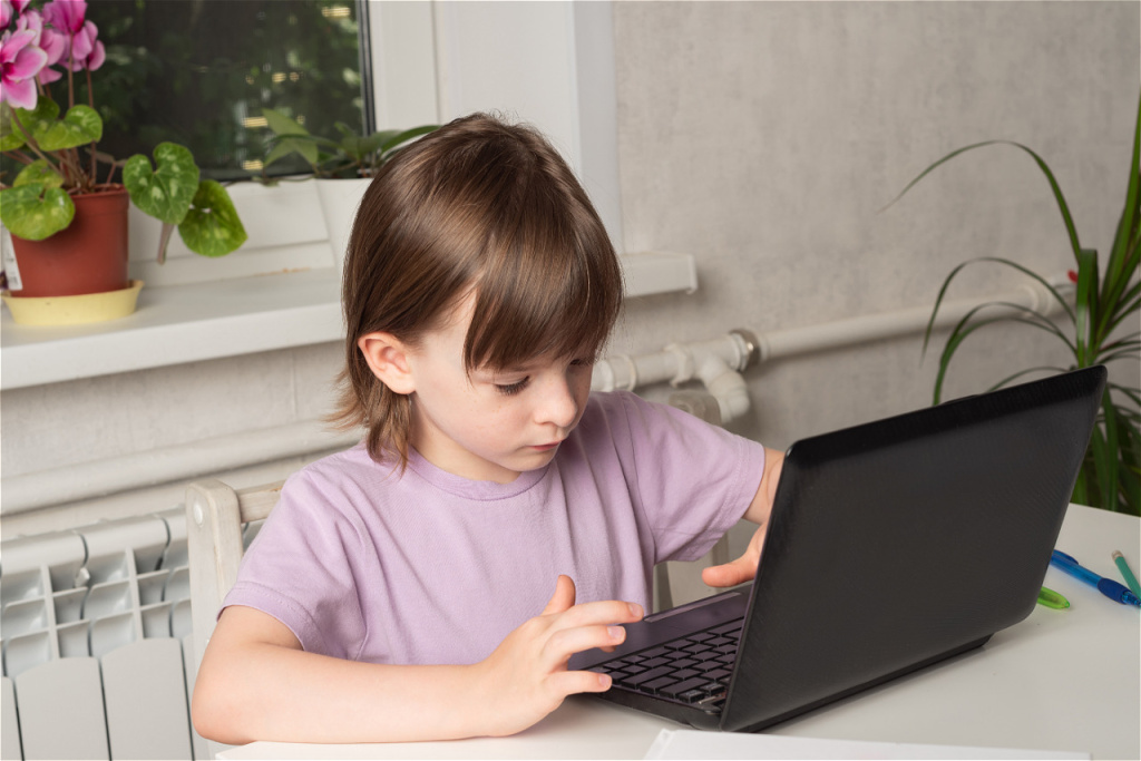 happy-girl-sits-at-a-table-with-books-and-works-on-2026-01-06-10-42-41-utc.jpg