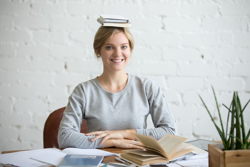 portrait-smiling-woman-desk-books-her-head.jpg portrait-smiling-woman-desk-books-her-head.jpg