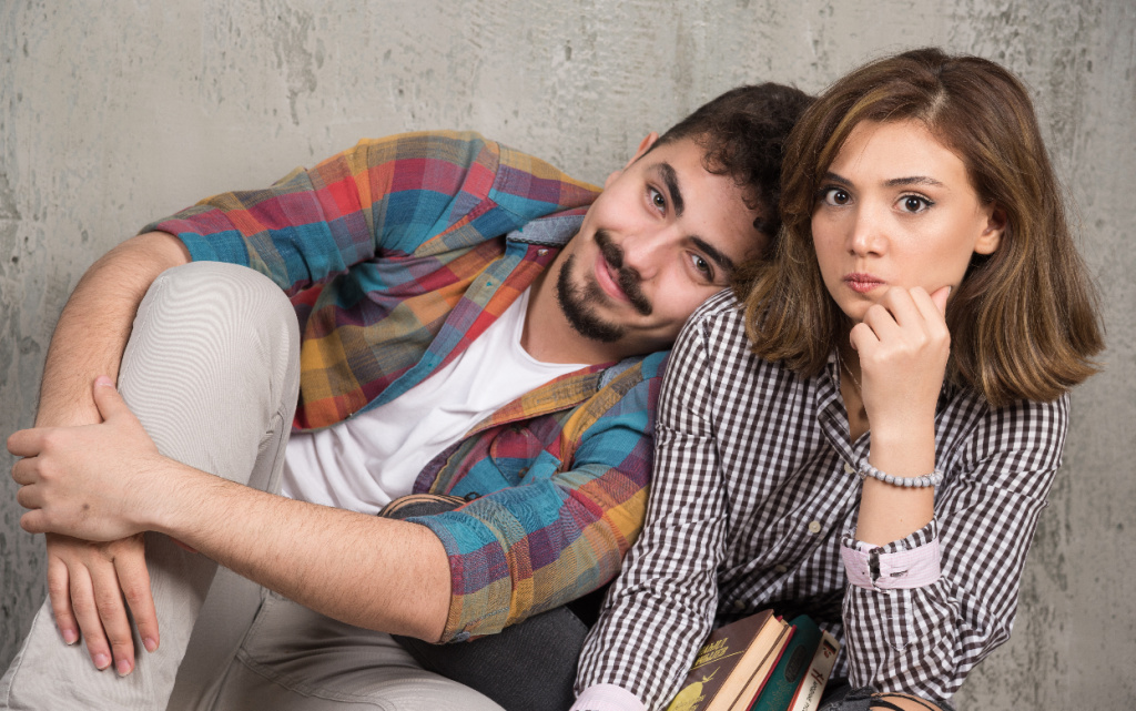 young-couple-sitting-floor-with-books (1).jpg