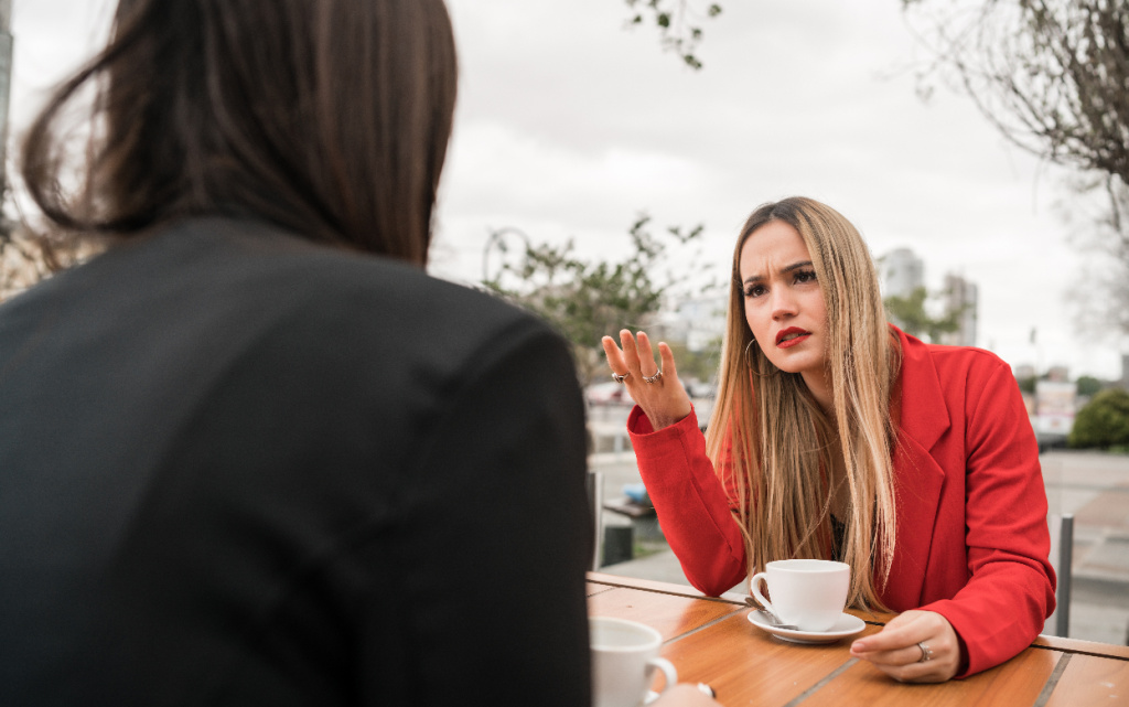woman-in-red-jacket-talking-with-friend-2026-03-26-10-05-33-utc (1).jpg