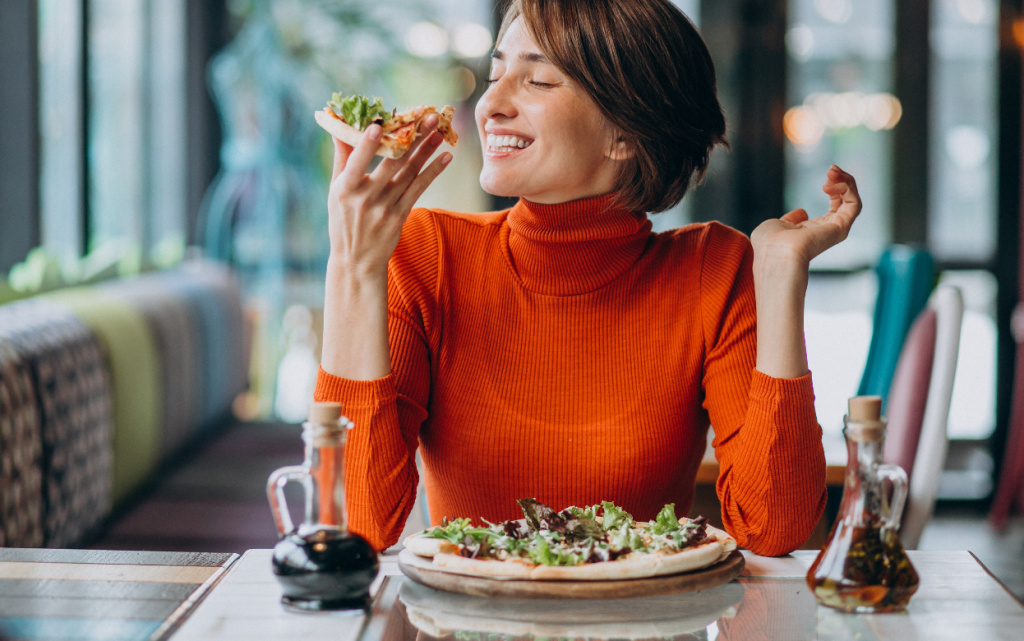 young-pretty-woman-eating-pizza-pizza-bar (1).jpg