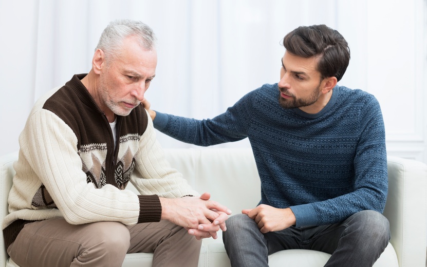 young-guy-with-hand-shoulder-aged-sad-man-settee (1).jpg
