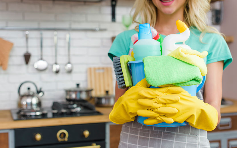 smiling-woman-with-cleaning-equipment-ready-clean-house.jpg