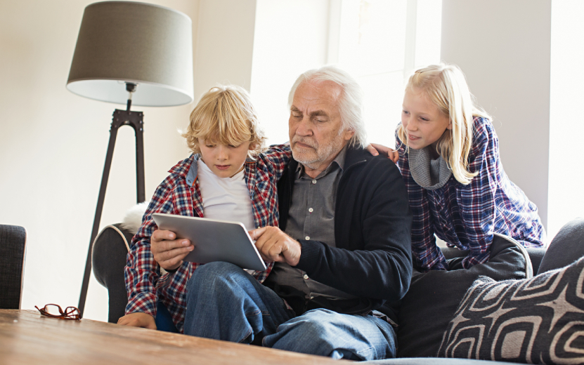 grandfather-using-digital-tablet-with-grandchildre-2023-11-27-05-08-30-utc.jpg