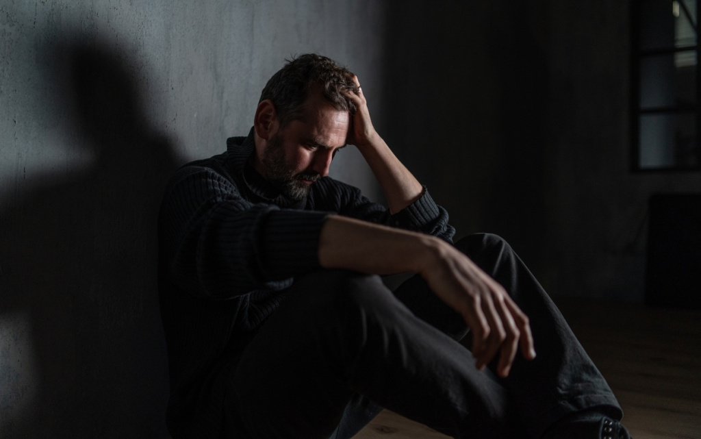 contemplative-man-sits-in-shadows-with-hand-on-hea-2026-01-05-06-32-00-utc (1).jpg