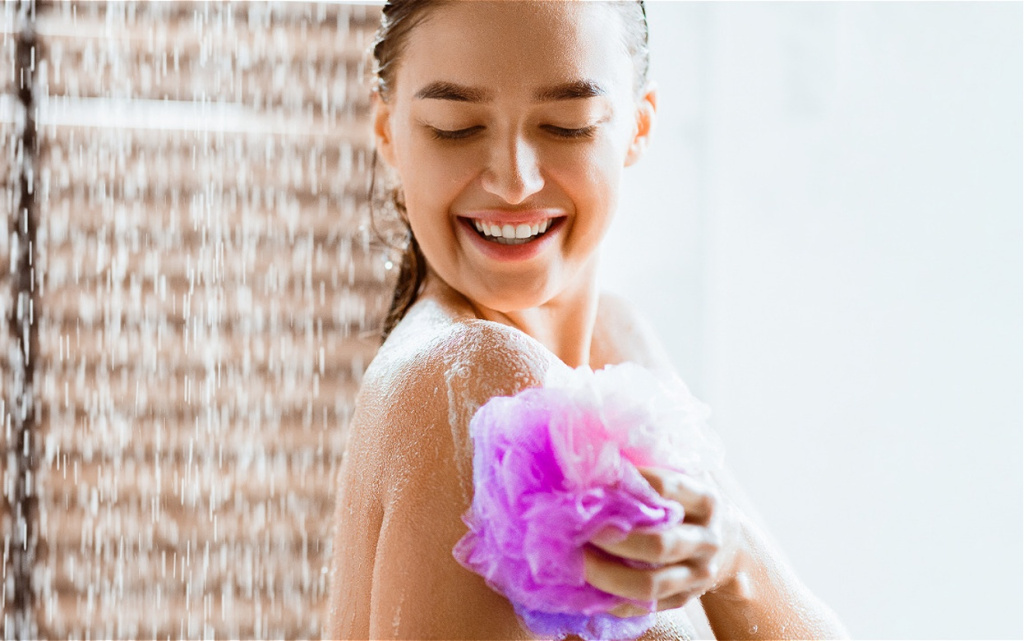 relaxing-woman-in-shower-with-purple-sponge-2026-03-24-02-27-43-utc (1).jpg