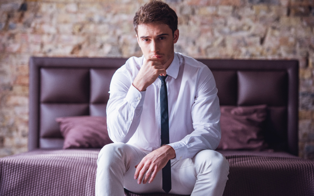 contemplative-man-sitting-on-bed-in-white-2026-09-21-02-08-34-utc (1).jpg