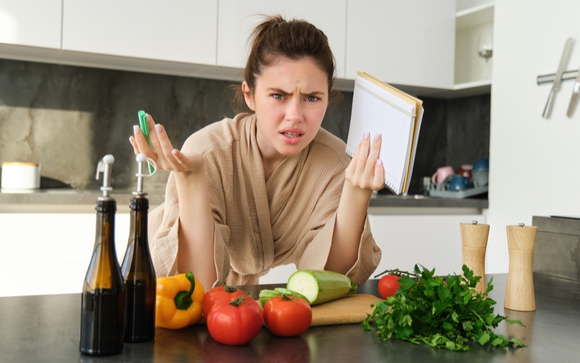 portrait-woman-cant-cook-looking-confused-while-making-meal-holding-recipe-book-checking-grocery (1).jpg