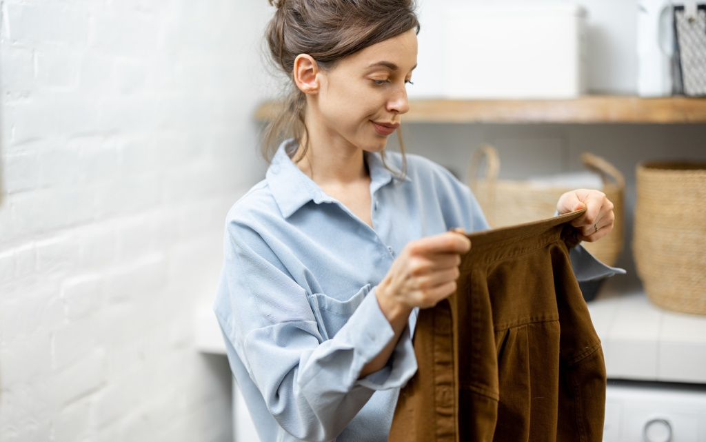woman-holding-a-brown-shirt-indoors-at-home-2026-09-22-03-10-22-utc (1).jpg