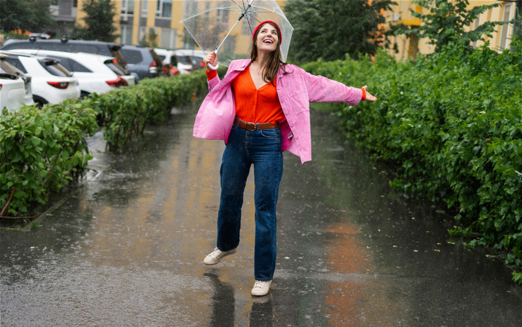 woman-enjoys-rainy-day-with-umbrella-2026-03-19-07-45-39-utc (1).jpg
