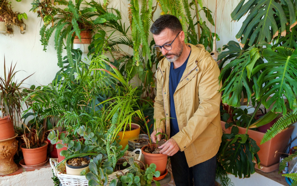 man-in-glasses-tending-to-potted-plants-on-a-green-2026-03-26-23-28-52-utc (1).jpg