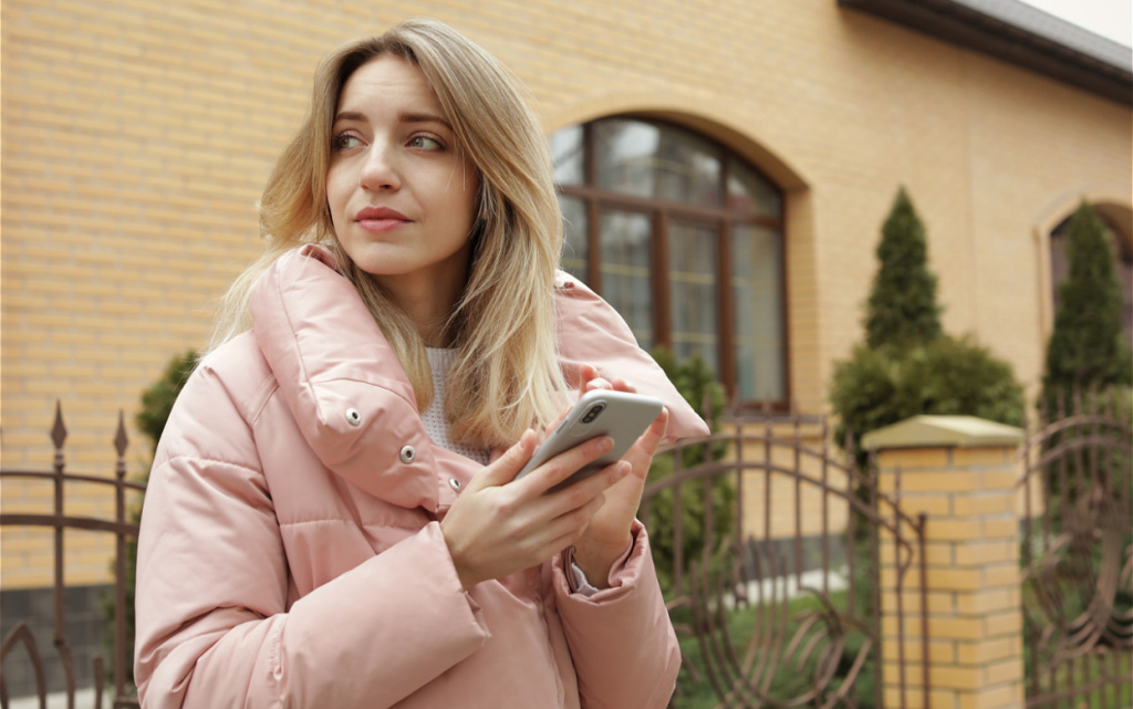 young-woman-uses-phone-outside-on-an-overcast-day-2026-03-08-23-05-10-utc (1).jpg