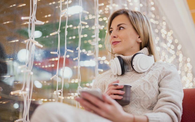 result_woman-with-headphones-around-neck-cup-near-christmas-lights.jpg