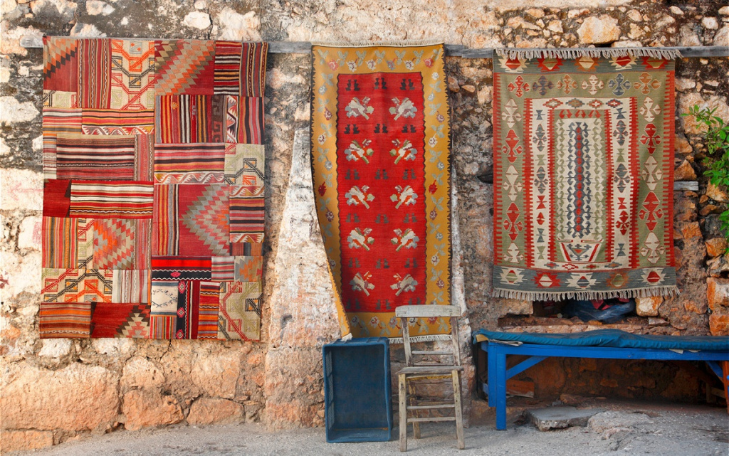 colorful-rugs-hang-on-weathered-stone-wall-2026-01-05-23-31-33-utc (1).jpg