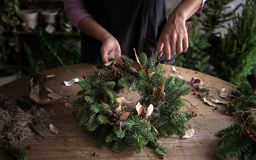 woman-making-christmas-wreath-of-spruce-step-by-s-2023-11-27-04-48-47-utc.jpg