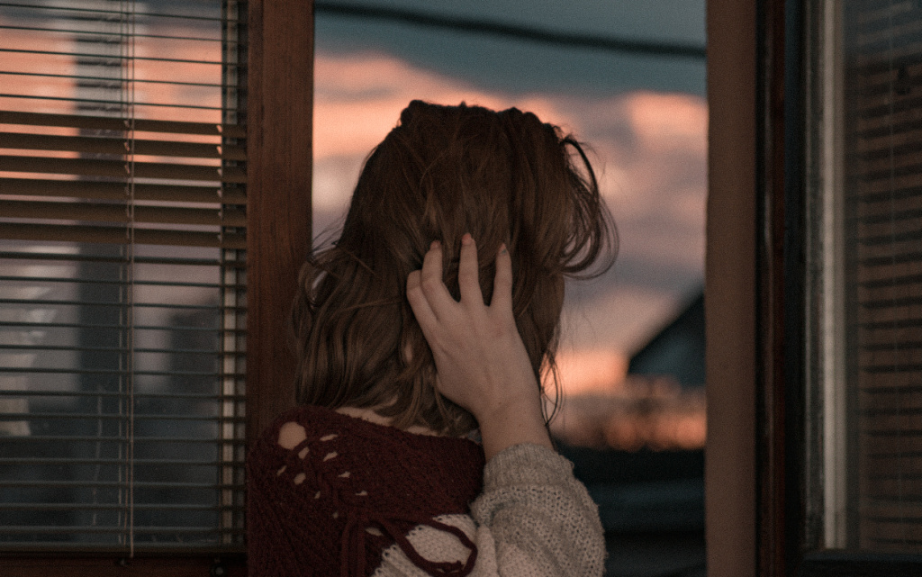 female-touching-her-hair-looking-outside-the-windo-2026-03-18-06-50-59-utc (1).jpg