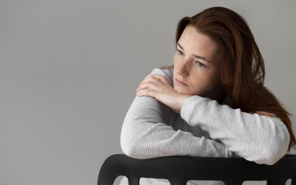 medium-shot-depressed-woman-sitting-chair (1) (1).jpg