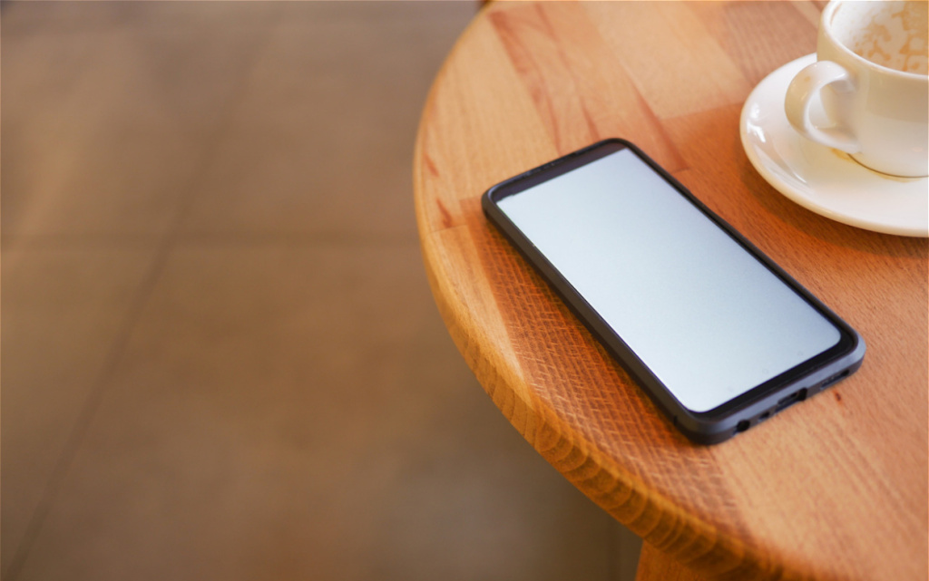 smartphone-and-coffee-cup-on-wooden-table-2026-01-09-11-35-05-utc (1).jpg