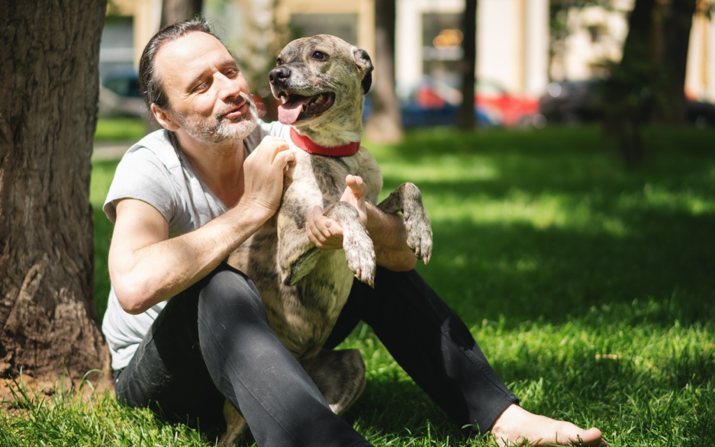 man-cuddling-dog-affectionately-in-green-park-2026-01-07-05-40-13-utc (1).jpg