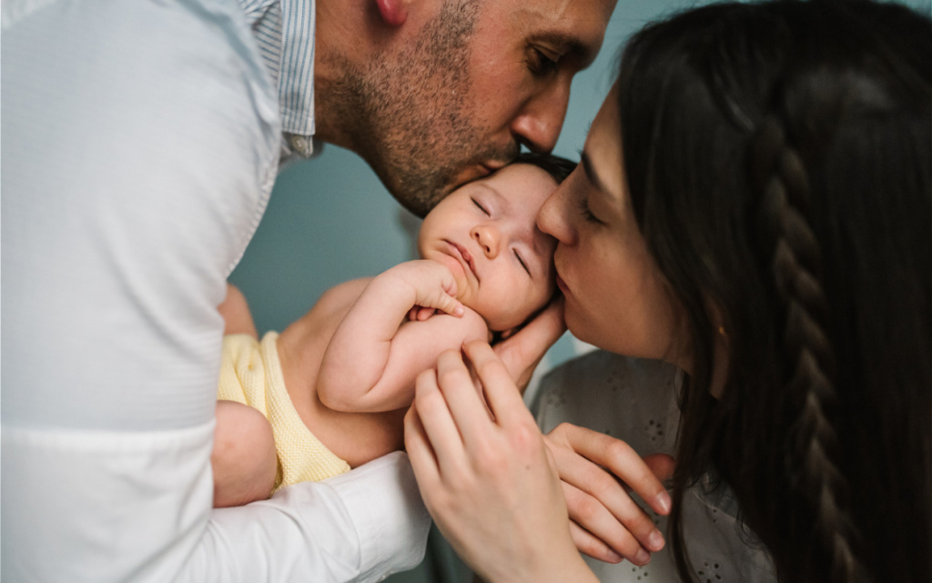 affectionate-parents-cradling-and-kissing-infant-a-2026-01-09-08-43-06-utc (1).jpg