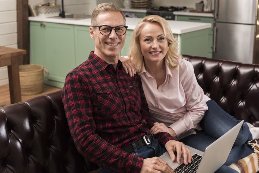 happy-parents-posing-with-laptop-sofa.jpg