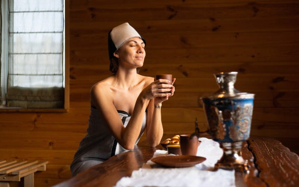 young-woman-sauna-with-cap-her-head-sits-table-drinks-herbal-tea-enjoying-wellness-day (1).jpg