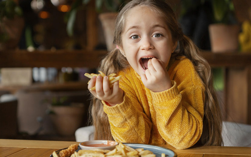 medium-shot-girl-eating-fri.jpg