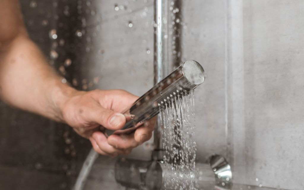 cropped-view-of-male-hand-holding-shower-behind-gl-2026-03-12-23-55-53-utc (1).jpg